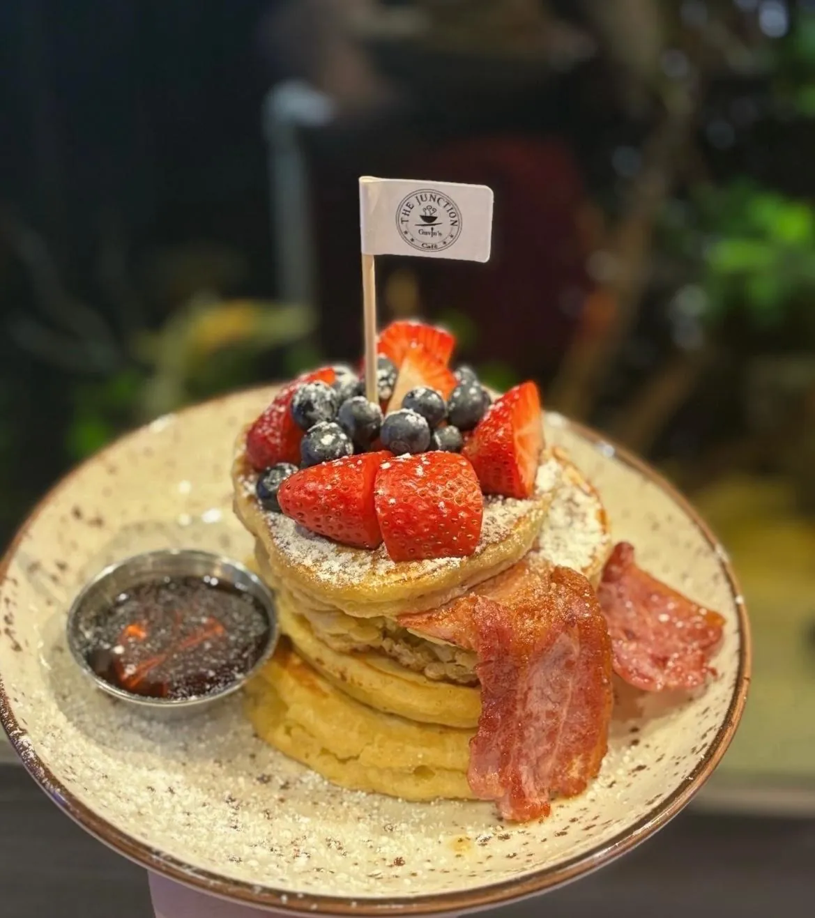 American style pancakes with berries, bacon and syrup