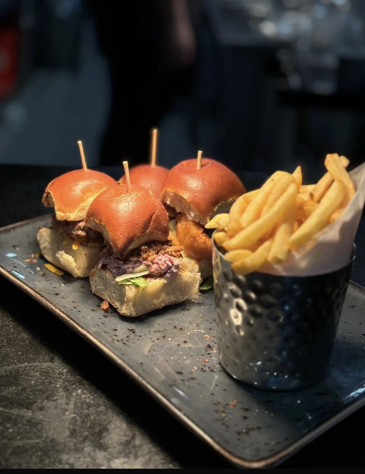 Mini burgers with fries in a steel bucket