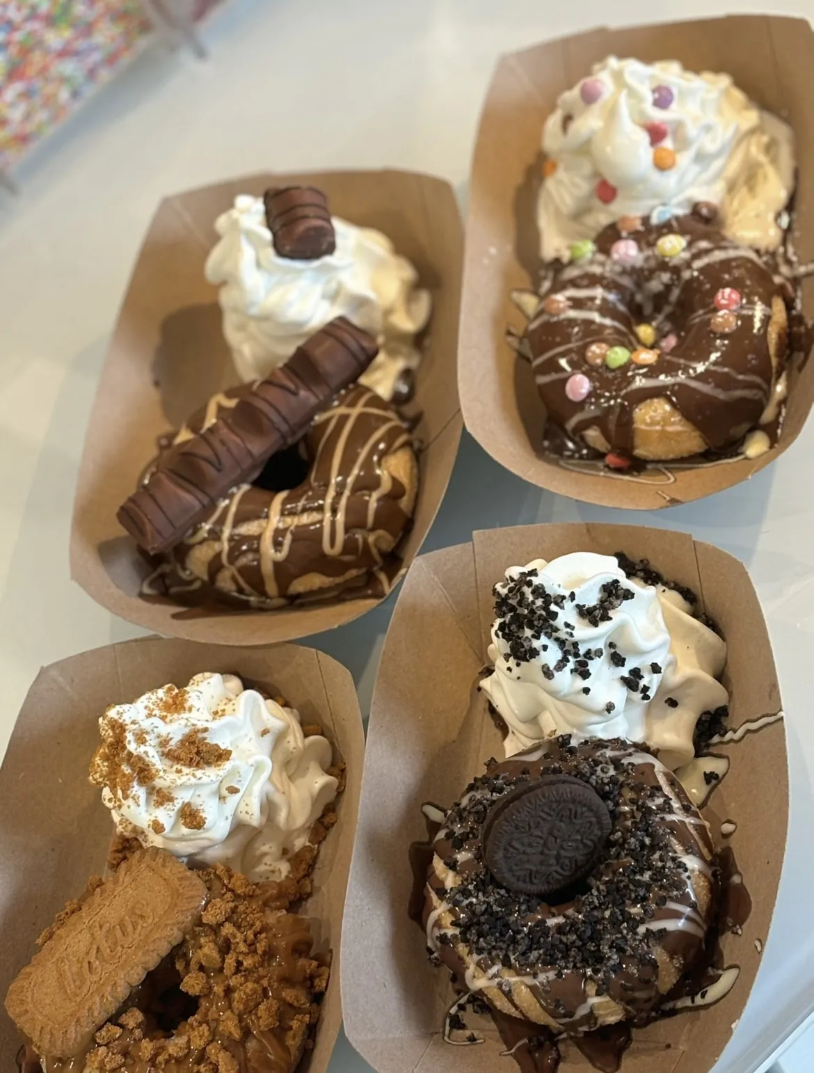 Four sweet boats with different toppings