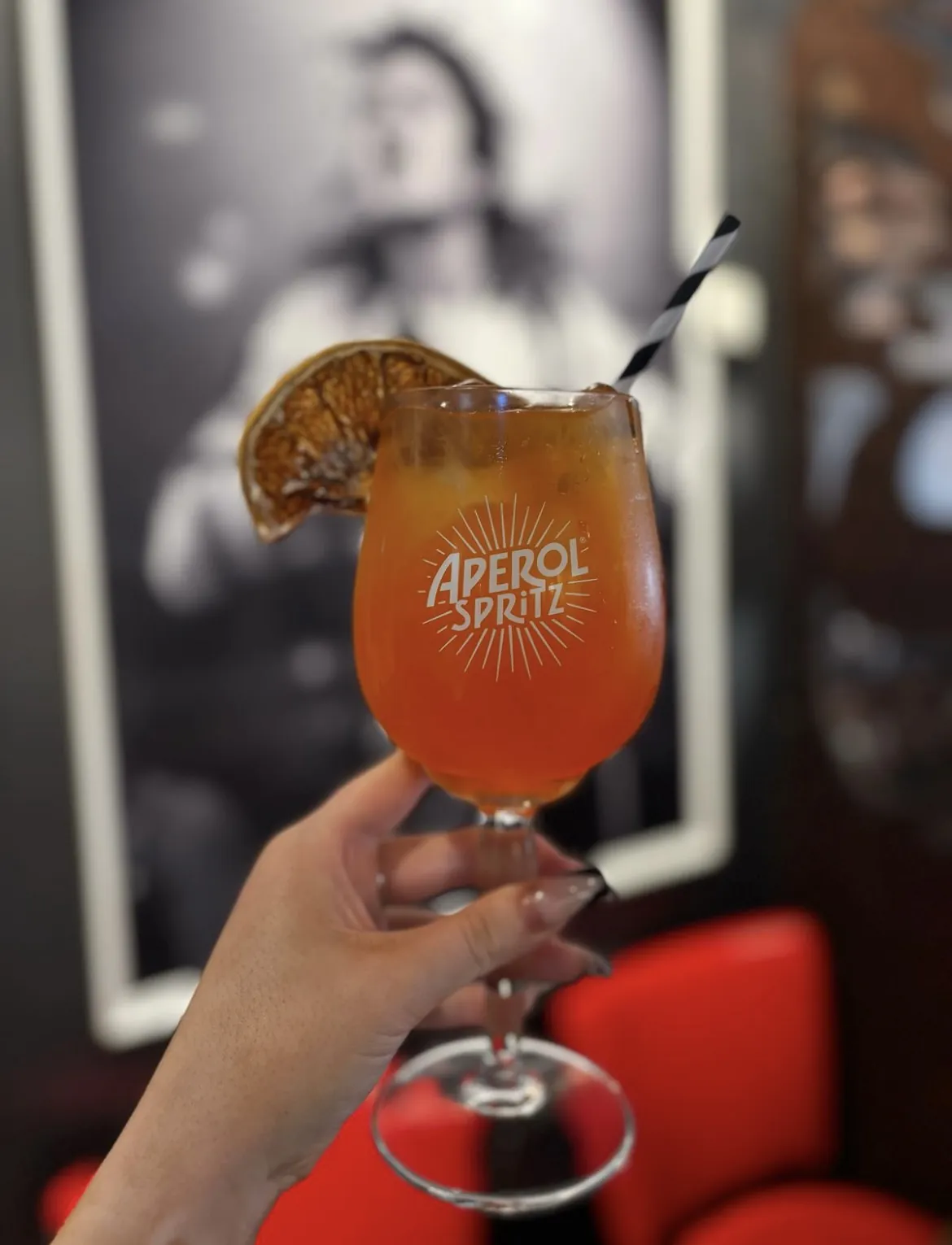 Aperol spritz in front of a rock portrait
