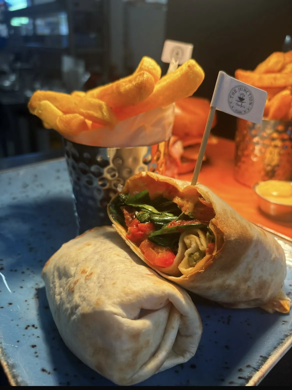 Wrap and fries on a speckled blue plate