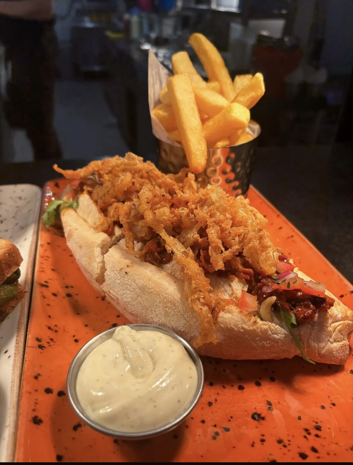 Pulled pork baguette with crispy onions and fries