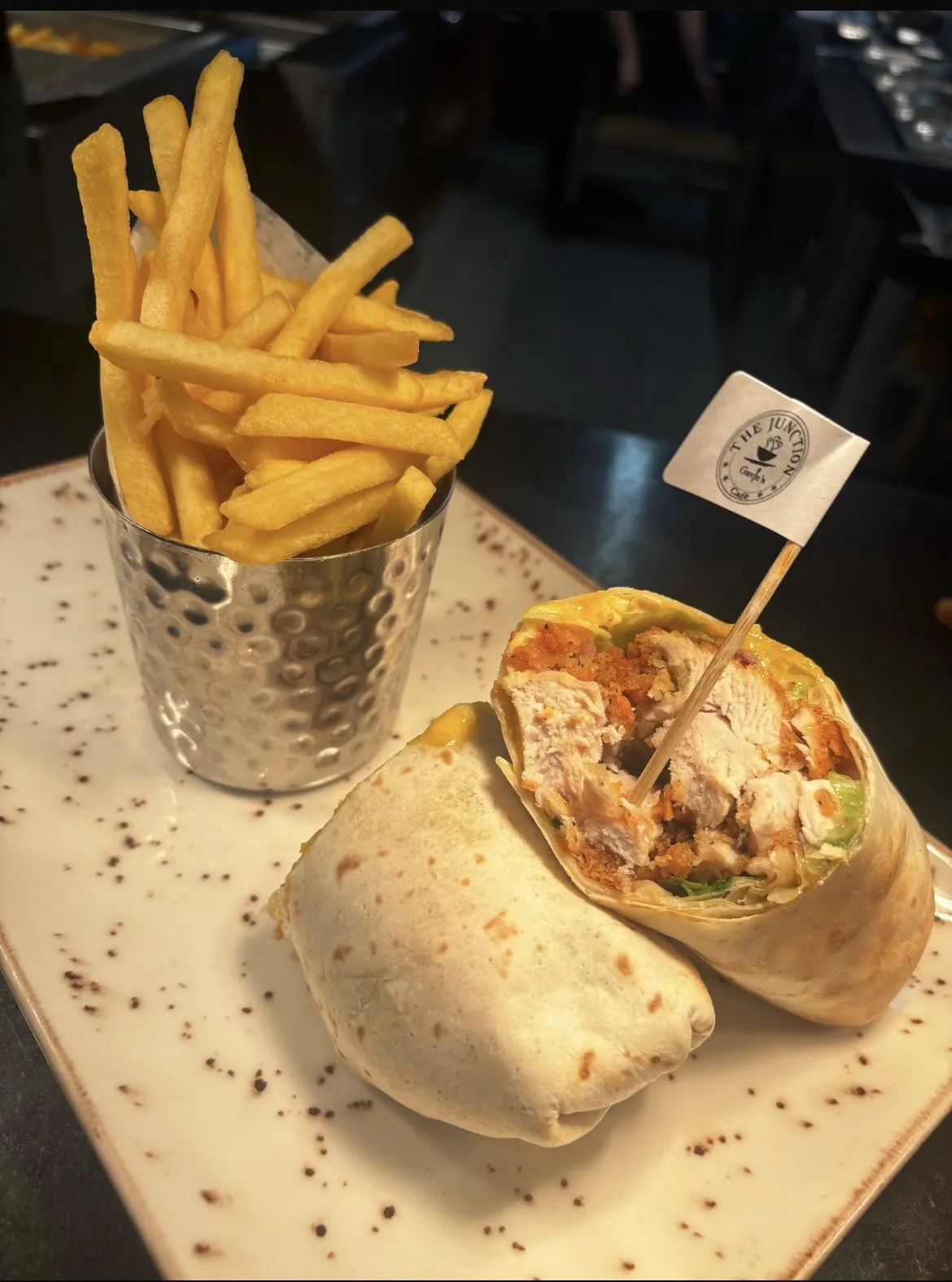 Chicken wrap with fries in a steel cup