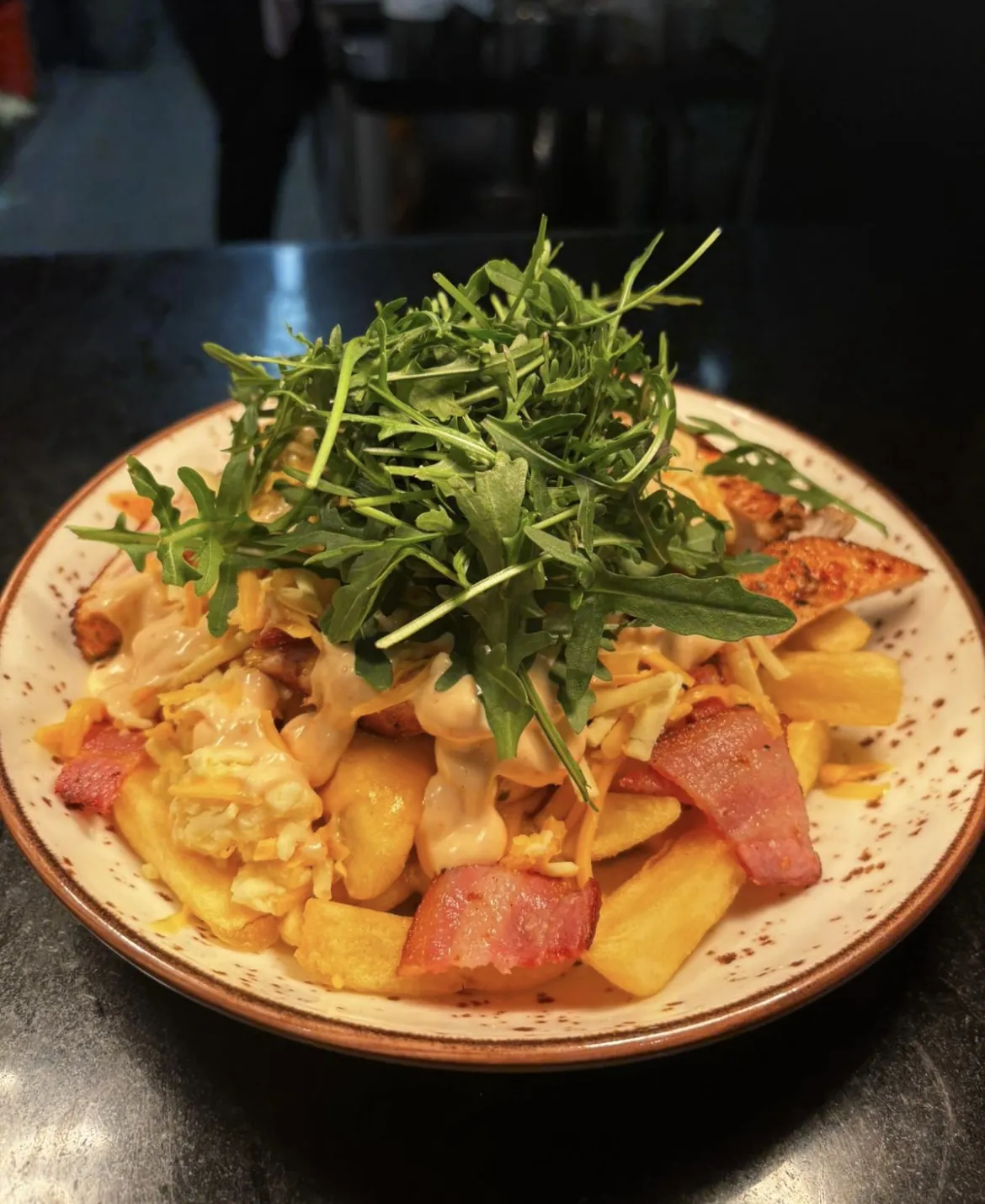 Pasta topped with rocket and bacon