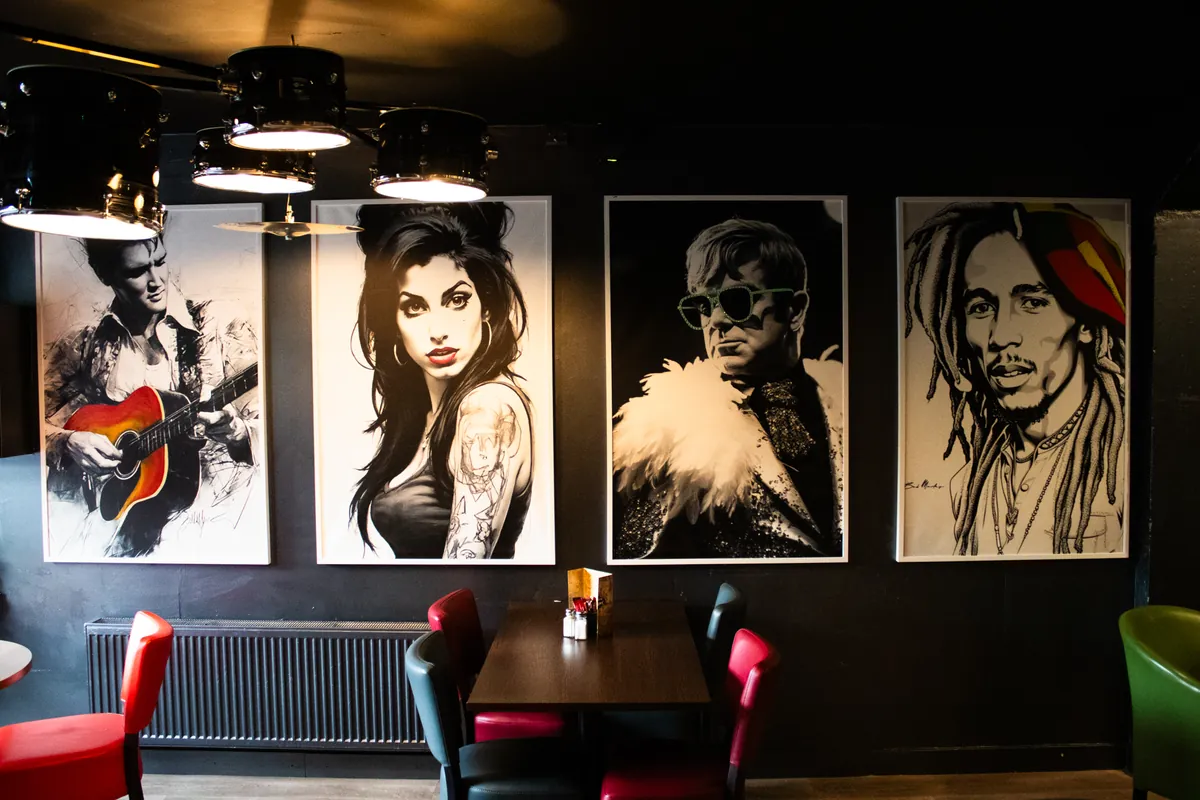 Black-and-white sketches of music icons above the booths