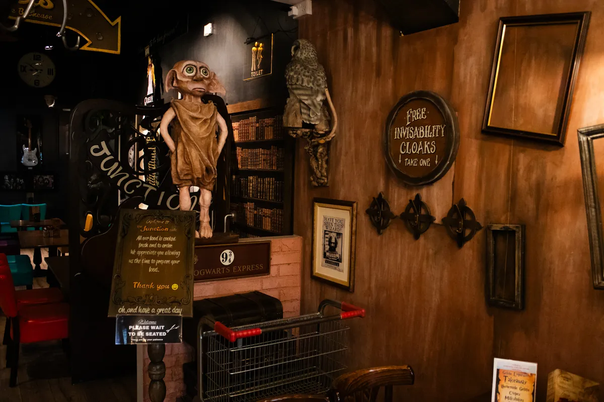 The wizarding corner with Dobby, frames and a painted brick wall