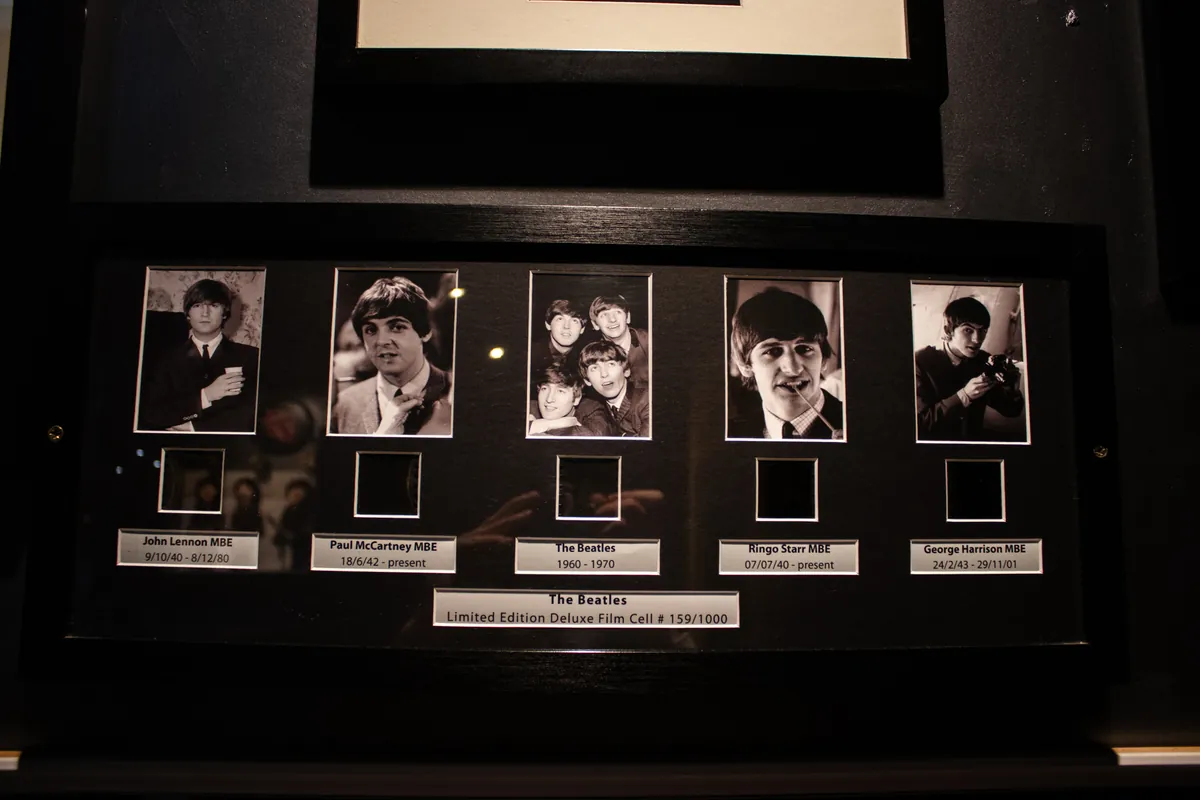 John, Paul, George and Ringo in one long frame, each above their own name plate.