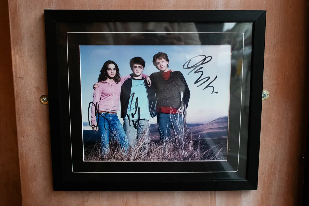 A framed photo of Harry, Ron and Hermione.